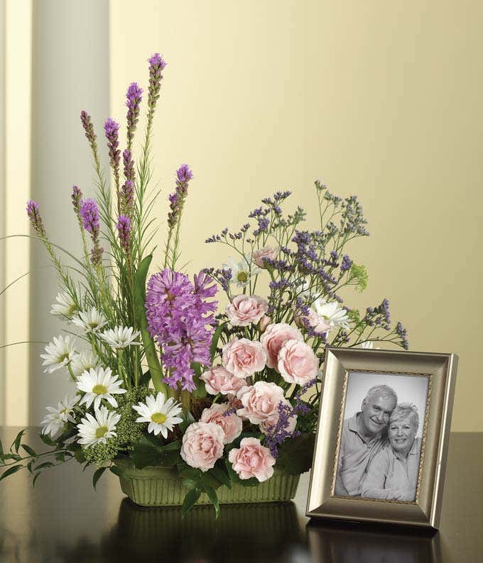 Pink spray roses, orchids and white daisy sympathy bouquet