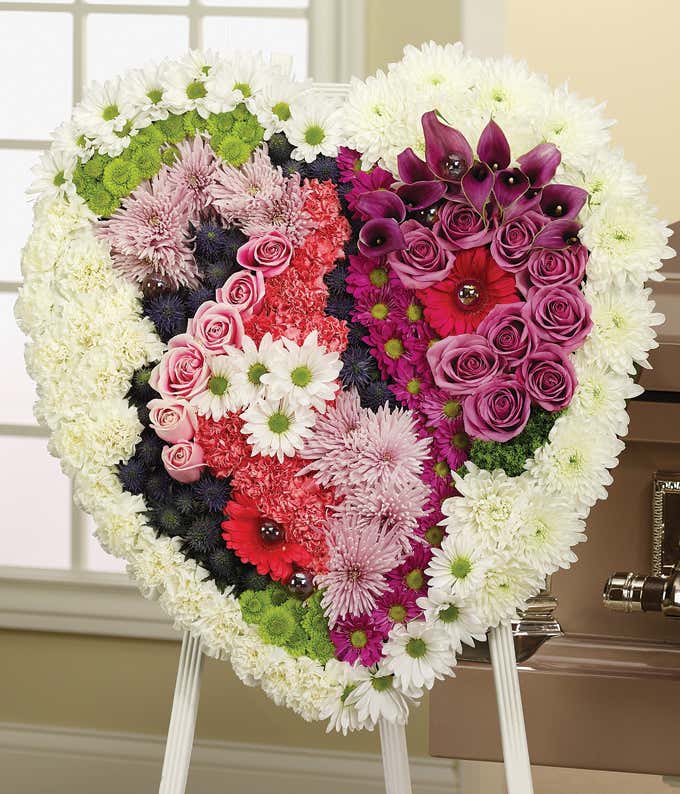 Heart shaped sympathy wreath with carnations, roses and daisies 