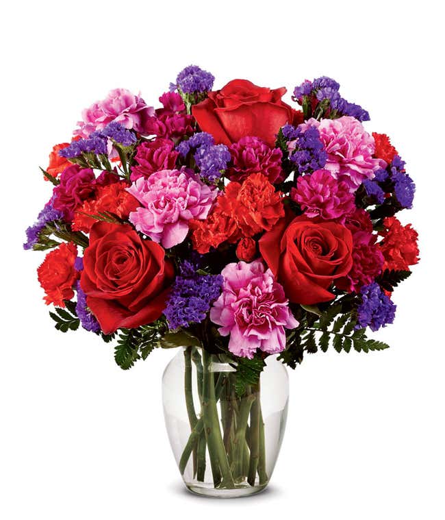 Red rose and hot pink carnations in modern red vase