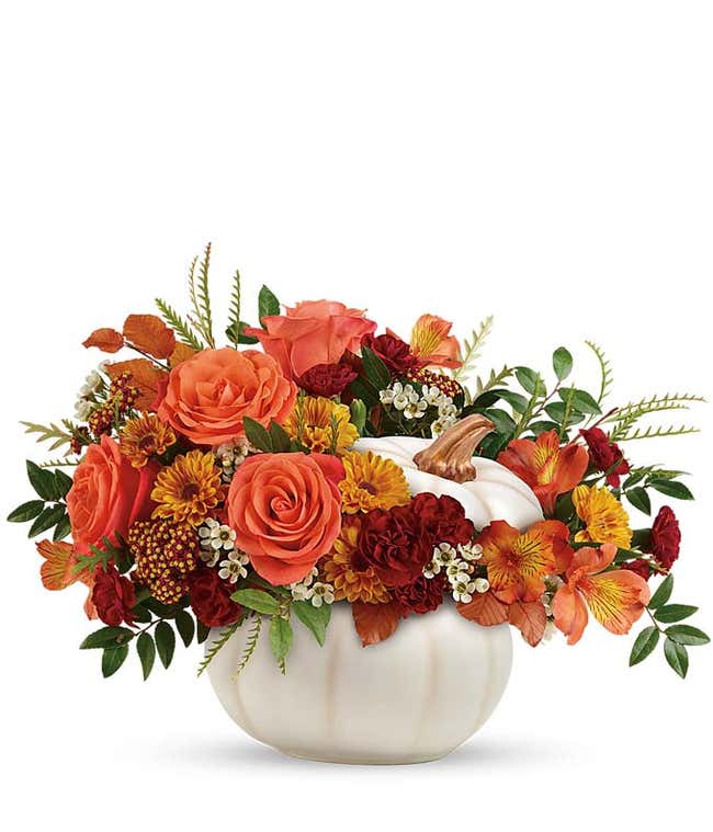 Orange Fall flowers arranged in a white pumpkin